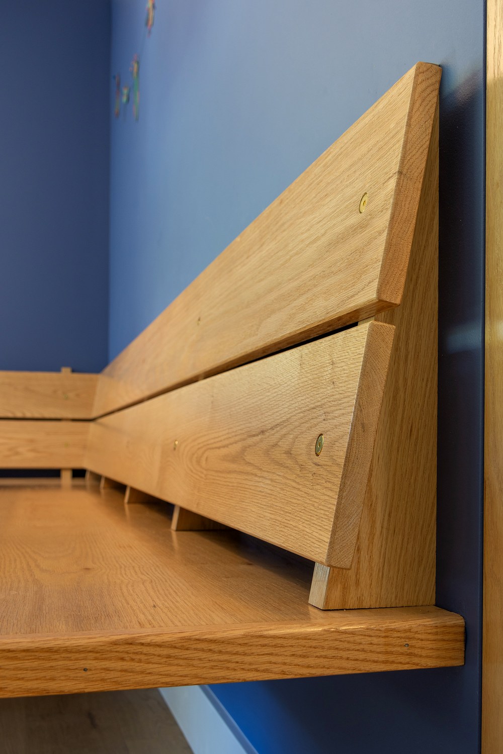 Close-up of the banquette's cantilevered, wall-mounted construction