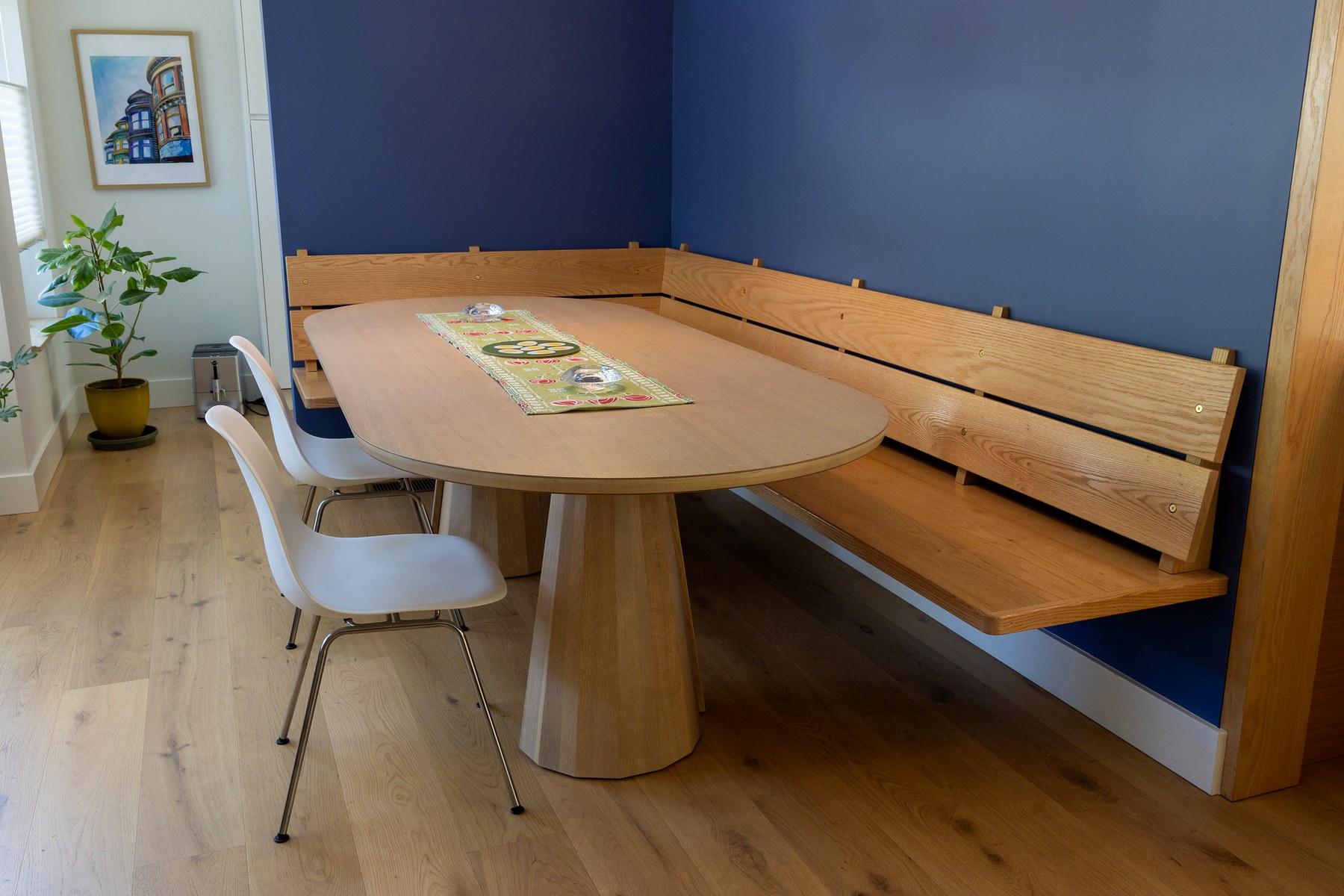 Oak corner banquette with oval dining table