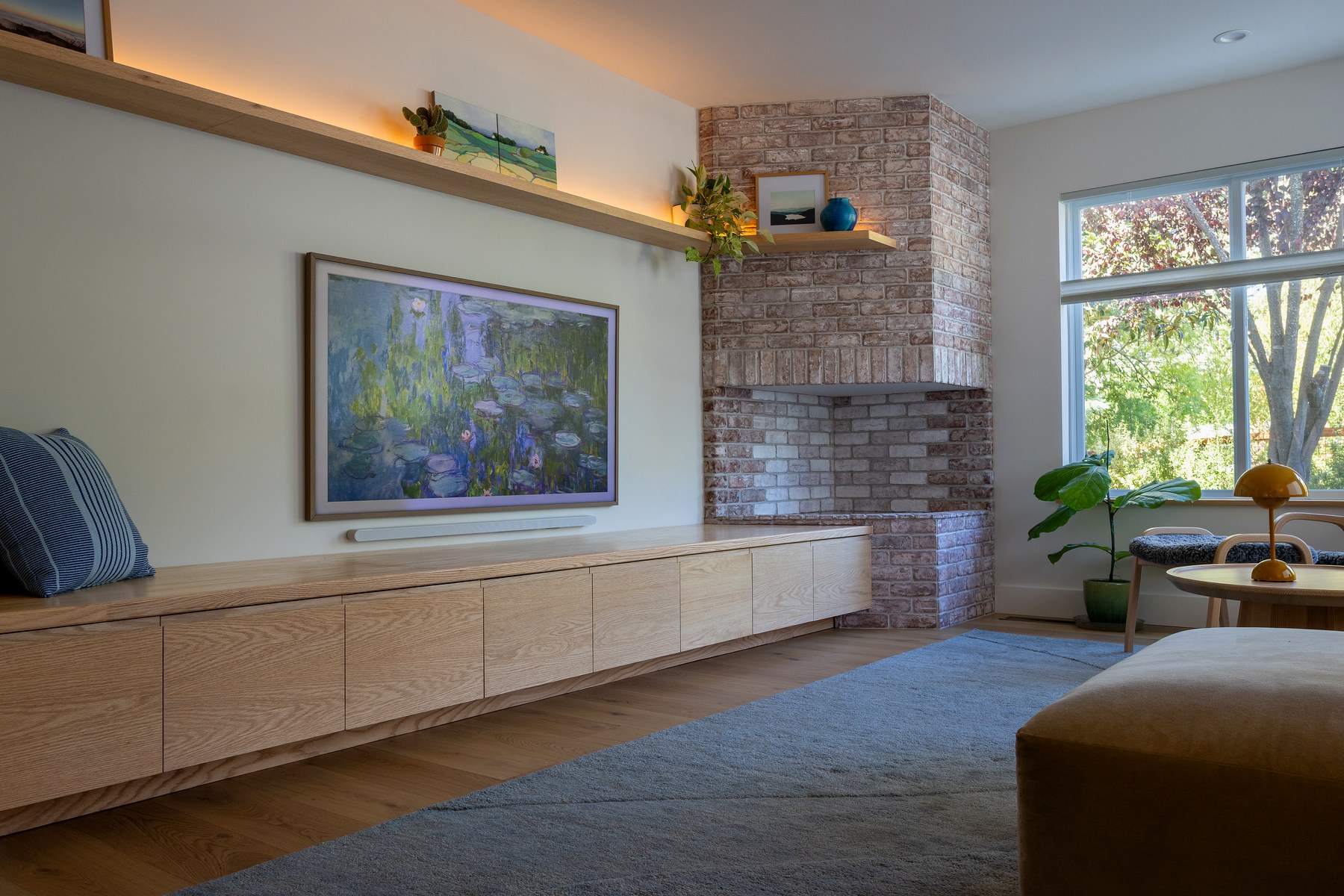 Oak fireplace bench and floating TV shelf in a living room