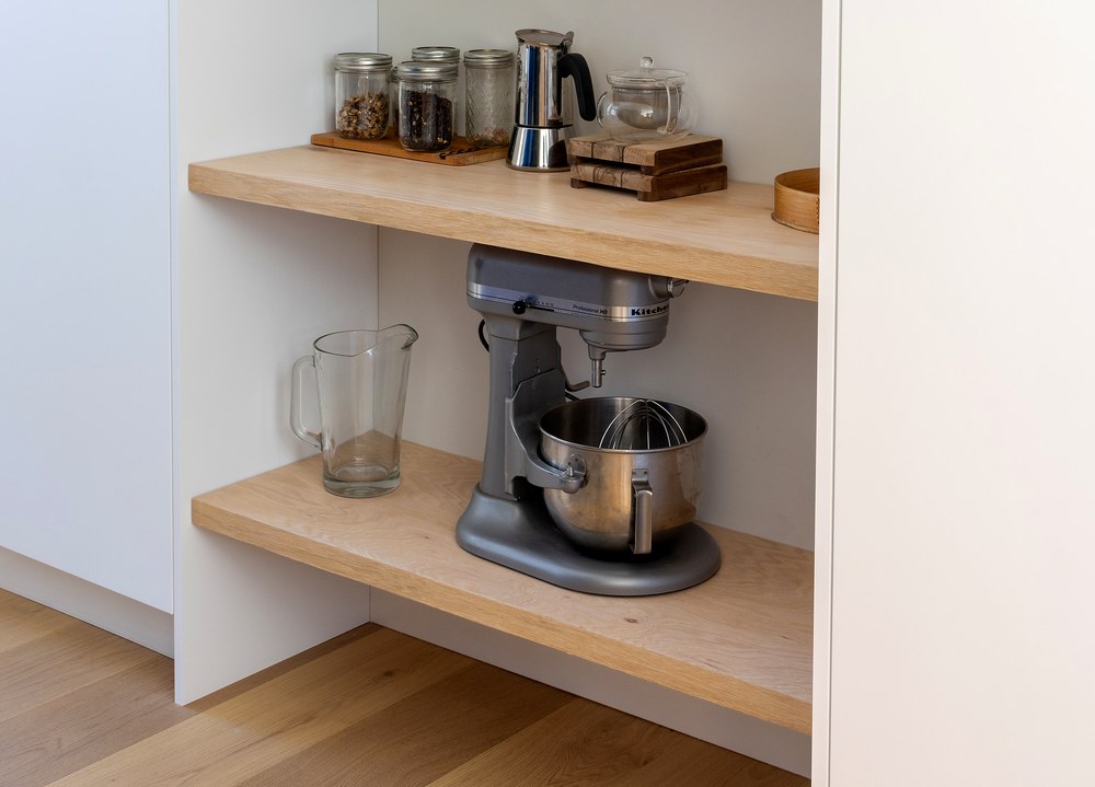 Lower pantry shelves holding a stand mixer and rice cooker