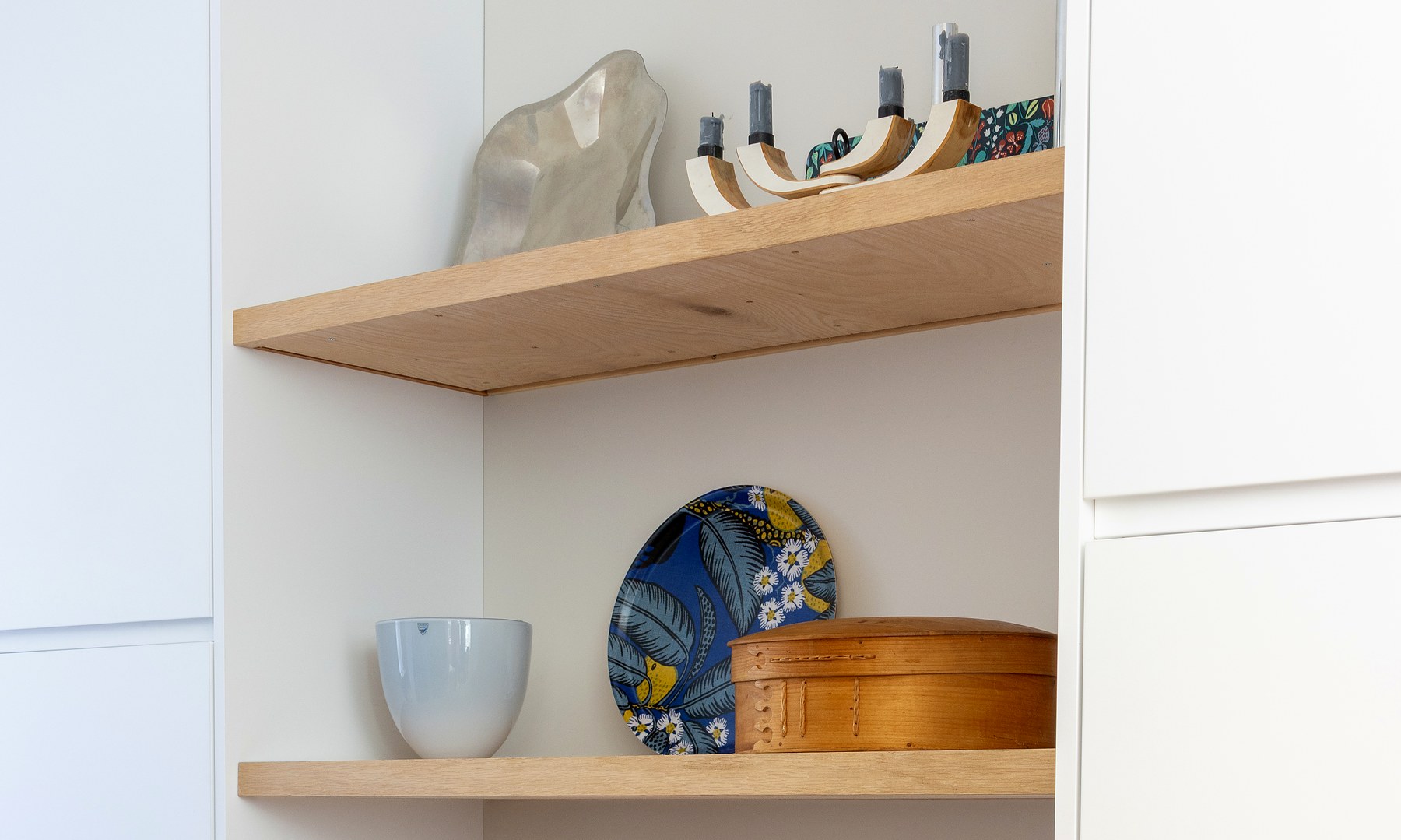 Floating oak pantry shelves styled with kitchenware