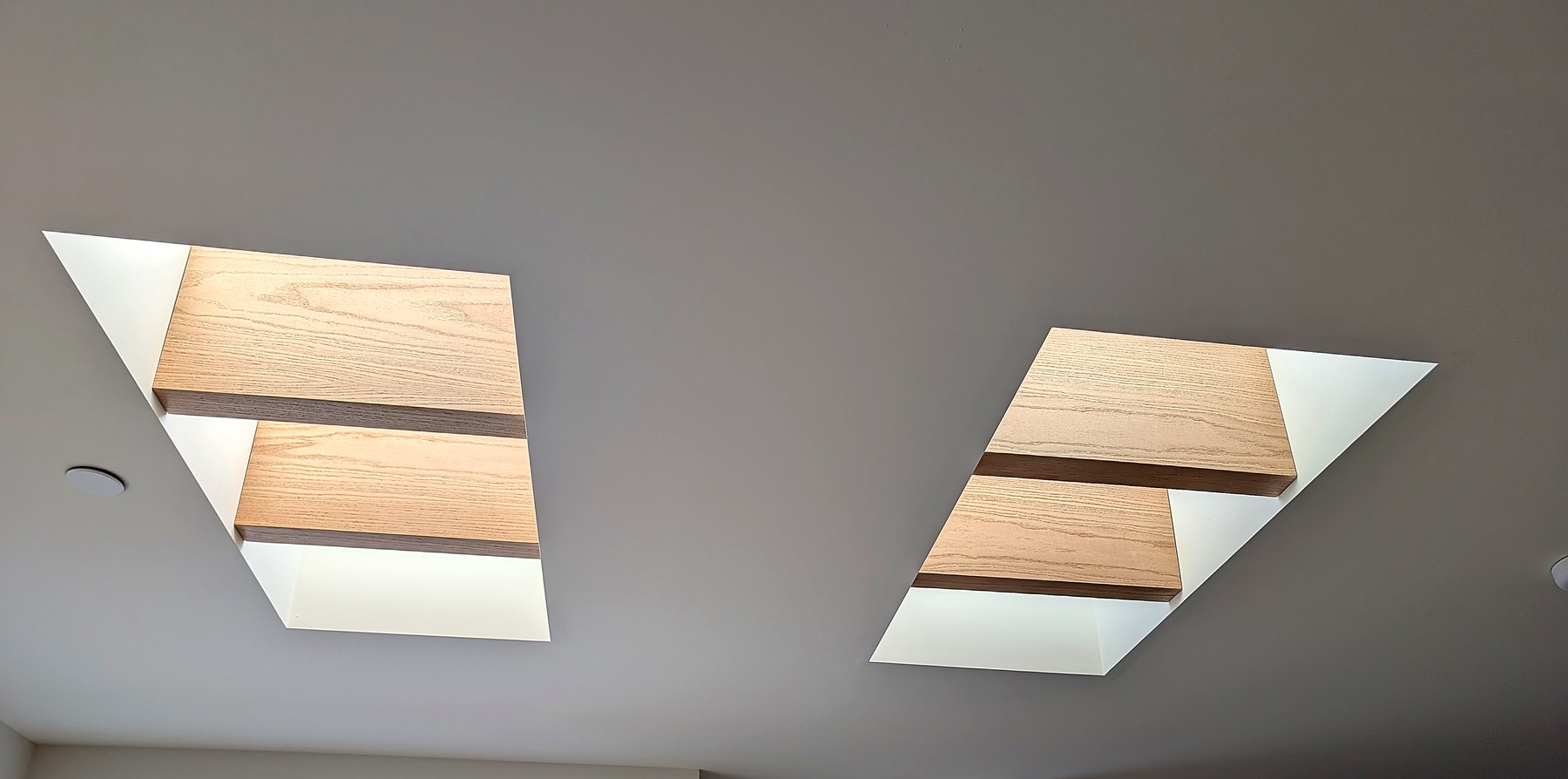 Two skylights framed with matching oak beams and walnut inlay