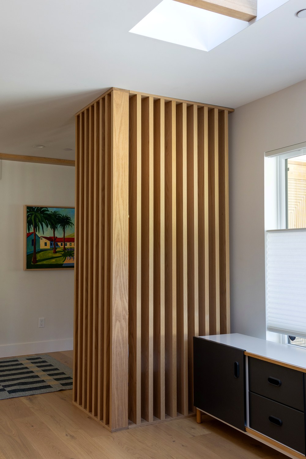 Slat wall dividing the foyer from the living room